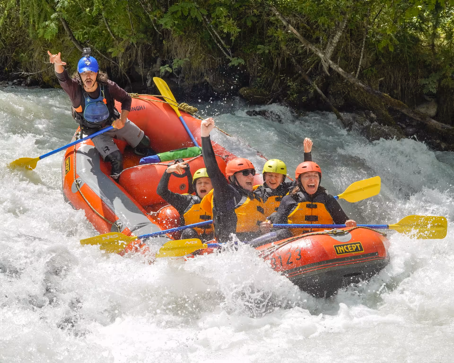 Excited group enjoying thrilling white-water rafting adventure on the Simme River amidst lush greenery.