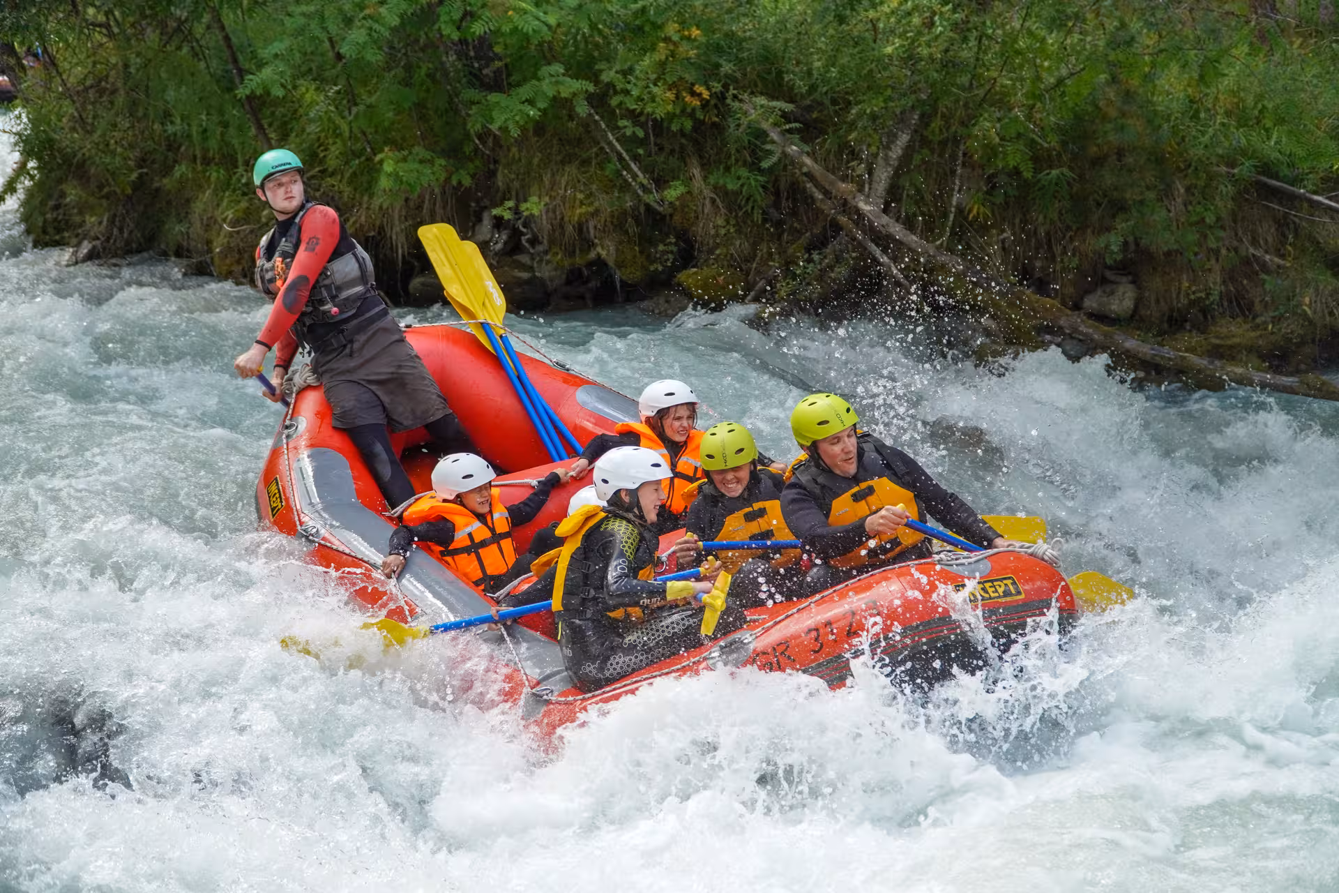 Excited rafters navigating white-water rapids on the Simme River, showcasing Fun For All's thrilling rafting tour.