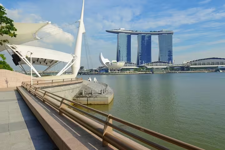 Marina Bay Sands towers and waterfront promenade along Singapore's historic waterway