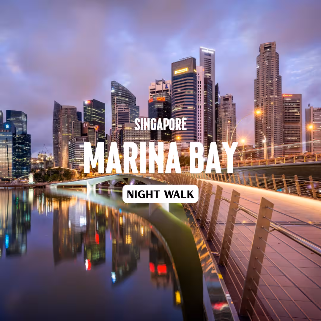 Illuminated Singapore Marina Bay skyline at dusk with reflections, highlighting the vibrant night walk experience.