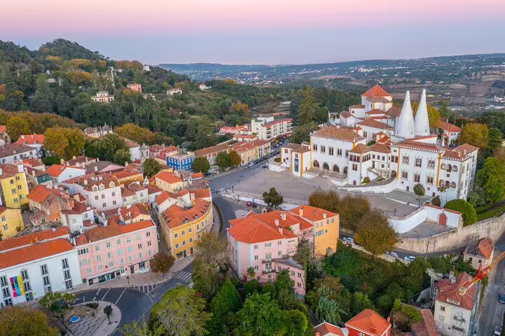 Aerial view of Sintra's vibrant town and historic architecture at sunset, highlighting the scenic beauty of the Lisbon full-day tour.