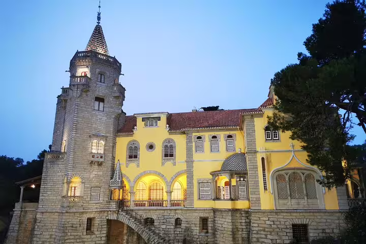 Charming view of Sintra's historical architecture at dusk, highlighting a picturesque castle on a Lisbon half-day tour.