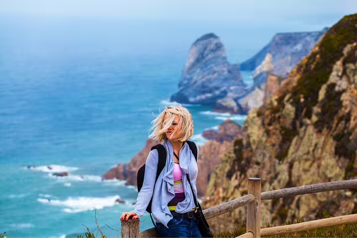 Traveler enjoying stunning coastal views on the Sintra, Cascais & Estoril Private Tour near the cliffs of Cabo da Roca.
