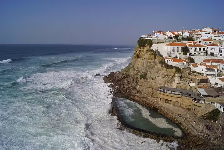 Breathtaking ocean view with cliffside houses in Cascais, seen on a private Jeep tour from Sintra to the coast.