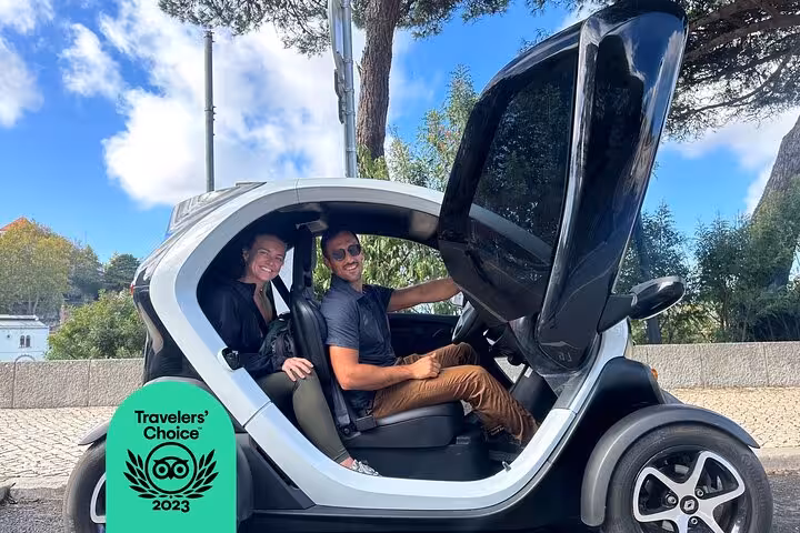 Smiling travelers in Renault Twizy for a Sintra self-drive tour, exploring palaces, viewpoints and coastline