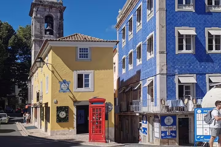 Charming street view in Sintra featuring colorful buildings and iconic architecture, perfect for the Pena Palace & Regaleira tour.