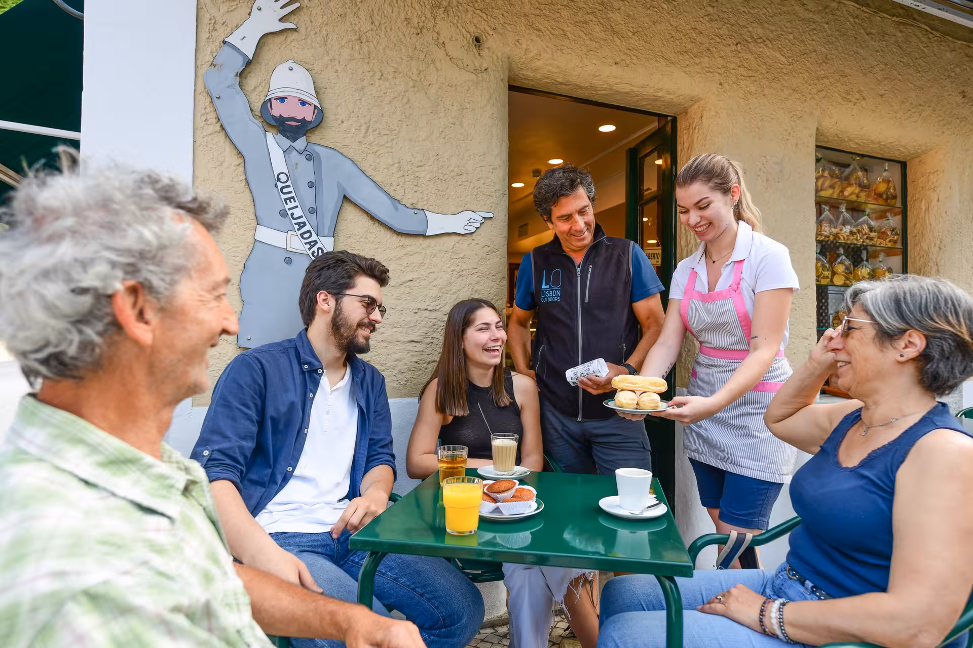 Group enjoying traditional pastries on the Sintra 5 Senses e-Bike Tour at a charming local café.