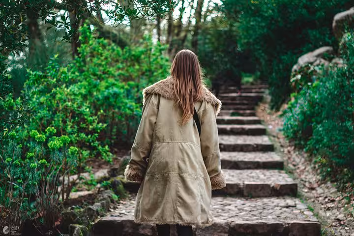 Traveler walking a forest path in Sintra, scenic nature stop on a self-drive monuments and coast tour