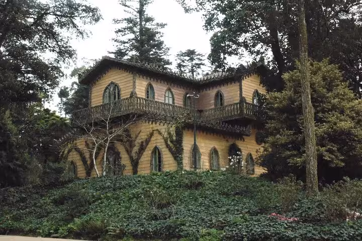 Charming historic house nestled among dense trees and greenery in Sintra, Portugal.