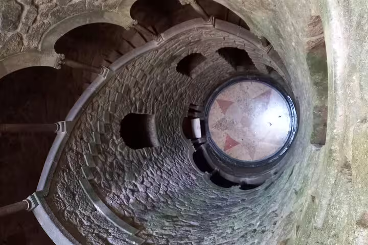Descend the enchanting spiral staircase at Sintra's Initiation Well on a private Lisbon or Cascais tour.