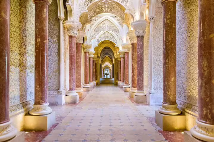 Ornate corridor in Sintra's Monserrate Palace with intricate arches and columns, featured on the Lisbon Sintra Highlights Tour.