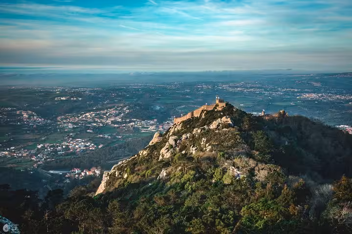Panoramic view of Sintra’s Moorish Castle ridge on a self-drive tour, with sweeping Lisbon coast views