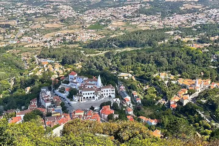 Aerial view of Sintra's lush landscape and historic architecture, highlighting landmarks on a half-day guided tour to Pena Palace.
