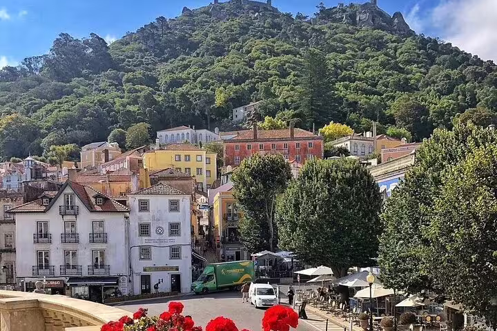 Charming Sintra townscape with colorful buildings and lush greenery, perfect for a half-day guided tour to Pena Palace.