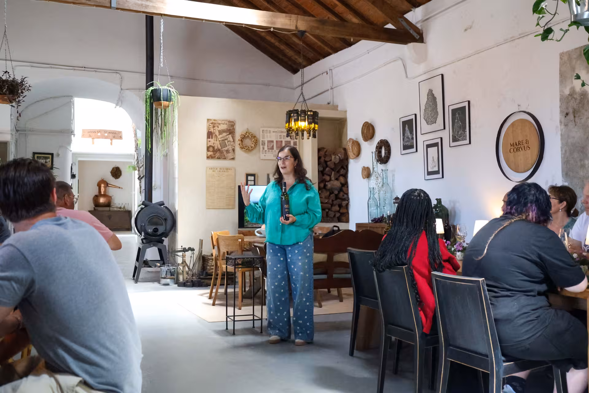 Tour group enjoying a wine tasting session in a rustic Portuguese winery during the Sintra small-group tour.