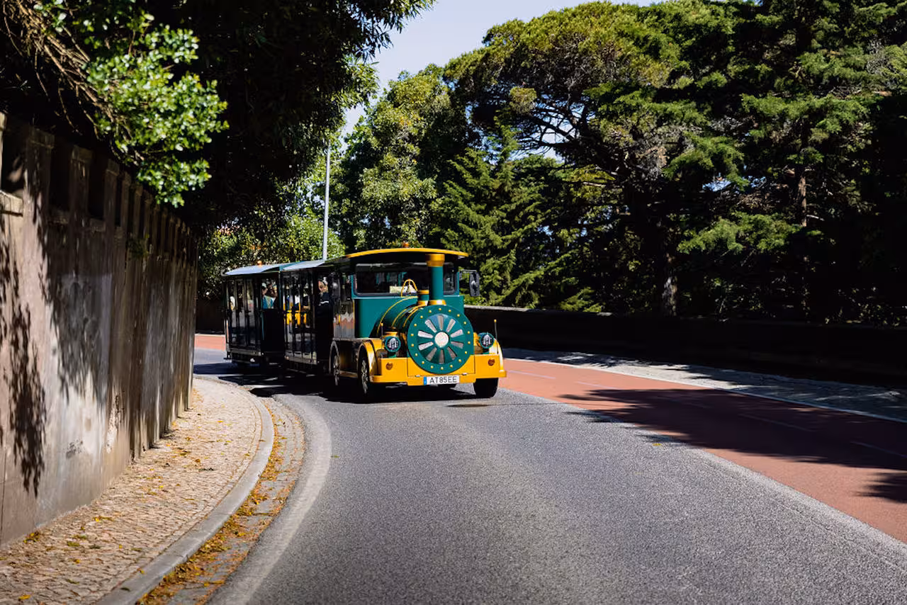 Sintra tourist road train on a scenic forest road, easy guided tour transport between top landmarks