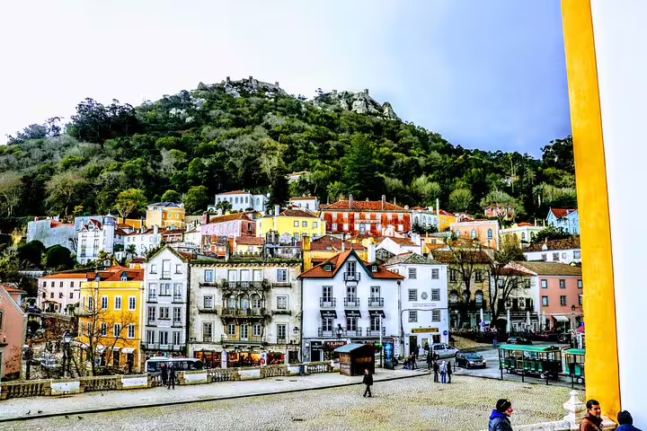 Charming Sintra village with colorful houses nestled against lush hills on a Lisbon guided day tour.