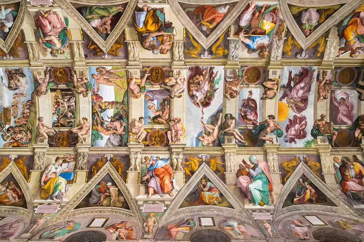 Ornate ceiling of the Sistine Chapel with Michelangelo frescoes, visited on Vatican Papal Audience and skip-the-line tours