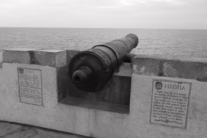 Historic cannon overlooking the sea in Sitges, offering a glimpse of the town’s rich maritime history.