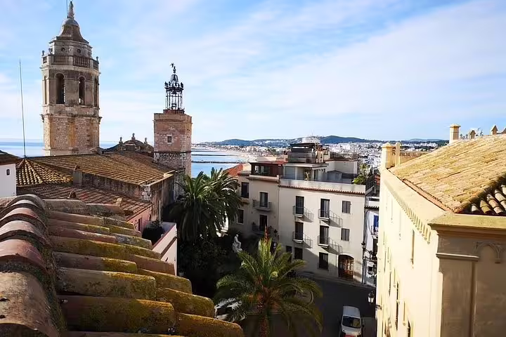 Scenic view of Sitges with historic towers and Mediterranean coastline on the Wine Celler Penedés tour.