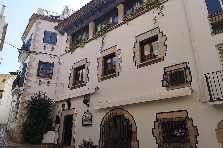 Charming traditional architecture in Sitges, showcasing local culture on the Wine Celler Penedés tour.