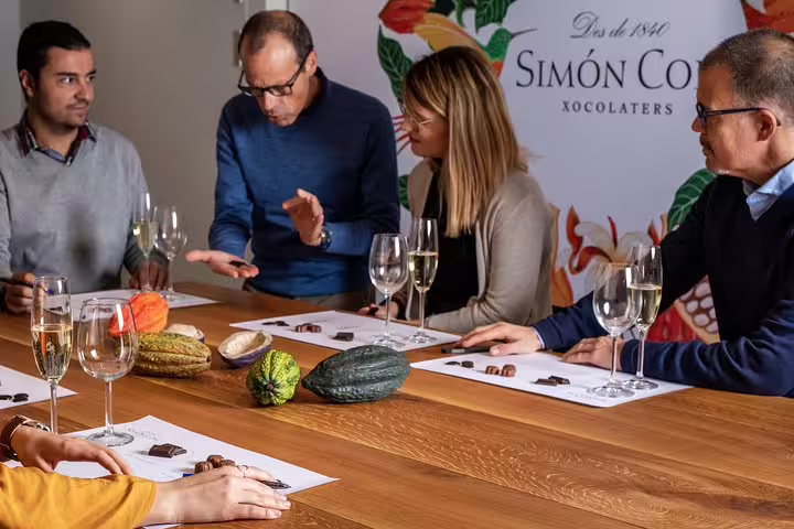 Group enjoying wine and chocolate tasting session, featuring local flavors in a Sitges private tour experience.