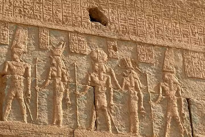 Ancient Egyptian temple relief carvings near Siwa Oasis, cultural stop on a 3-day Sahara safari tour