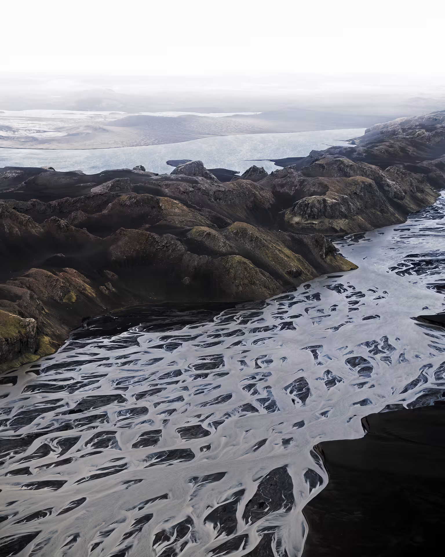 Aerial view of braided glacial riverbeds on black sand plains near Skaftafell glacier, Iceland