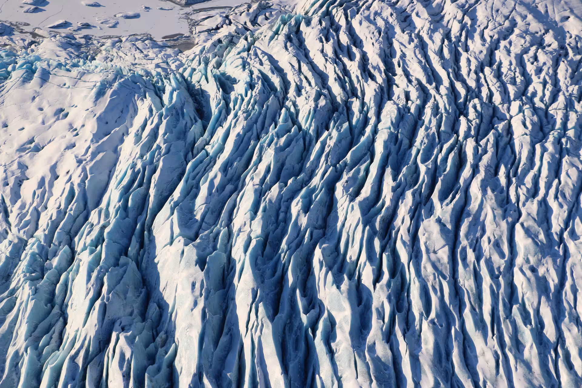 Aerial view of heavily crevassed glacier ice with deep blue seracs in Skaftafell Iceland