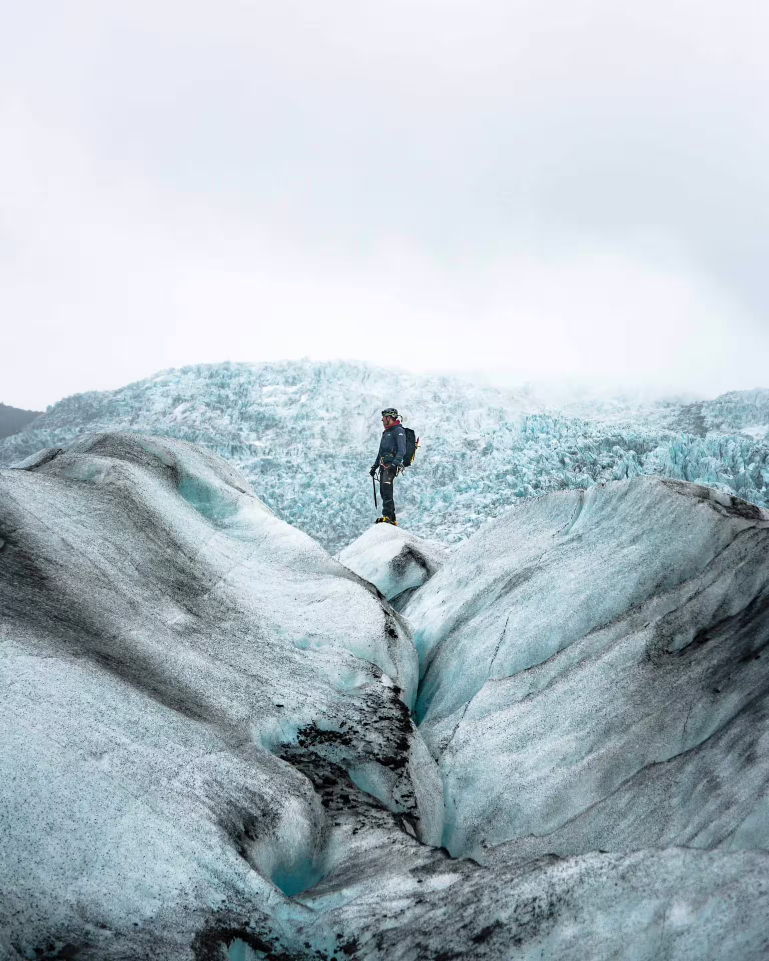 Guide standing on Skaftafell glacier ice formations during a 5-hour guided glacier hike in Iceland