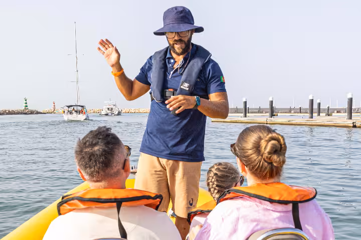 Skipper briefing guests at Vilamoura Marina before a private dolphin watching boat trip along the Algarve coast