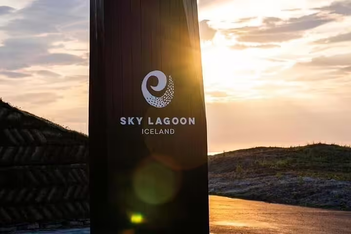 Sky Lagoon Iceland entrance sign at sunset with golden sky backdrop