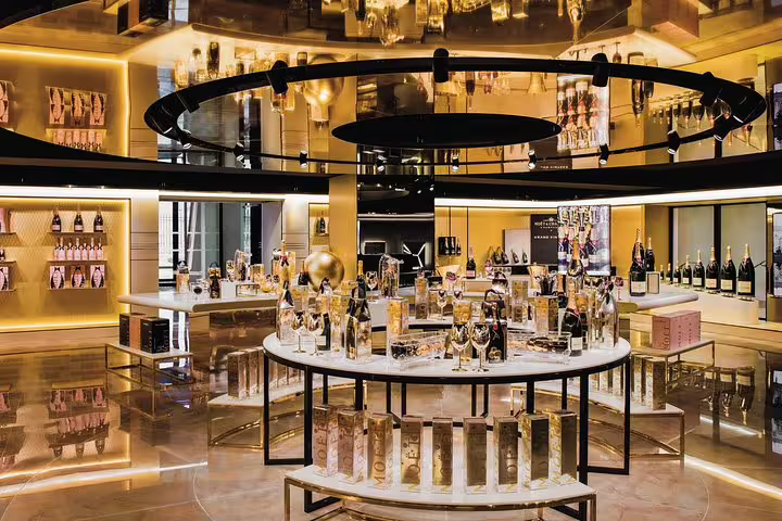 Elegant Champagne tasting room visit on small-group day trip from Paris, featuring premium bottles and displays