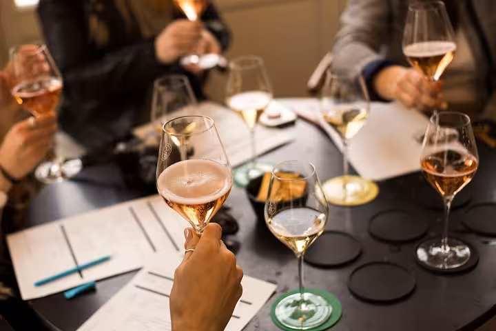 Guests tasting rosé and blanc Champagne at a guided workshop on a small-group day trip from Paris with lunch
