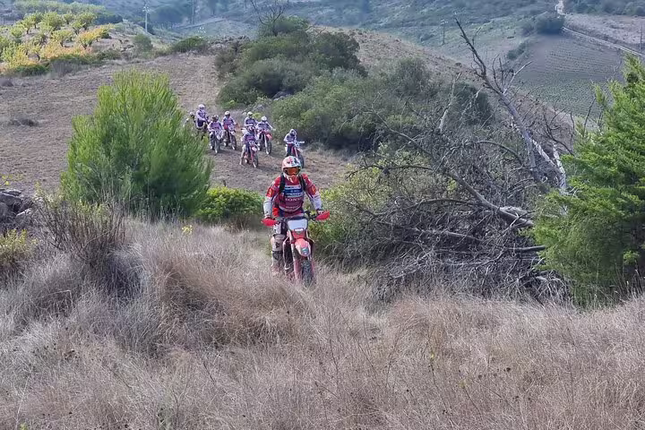 Riders navigate rugged trails during a small group enduro tour in Lisbon's scenic hills.