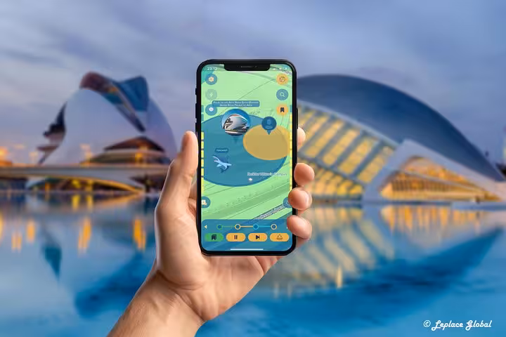 Hand holding smartphone with navigation app for self-guided Valencia walking tour at City of Arts and Sciences