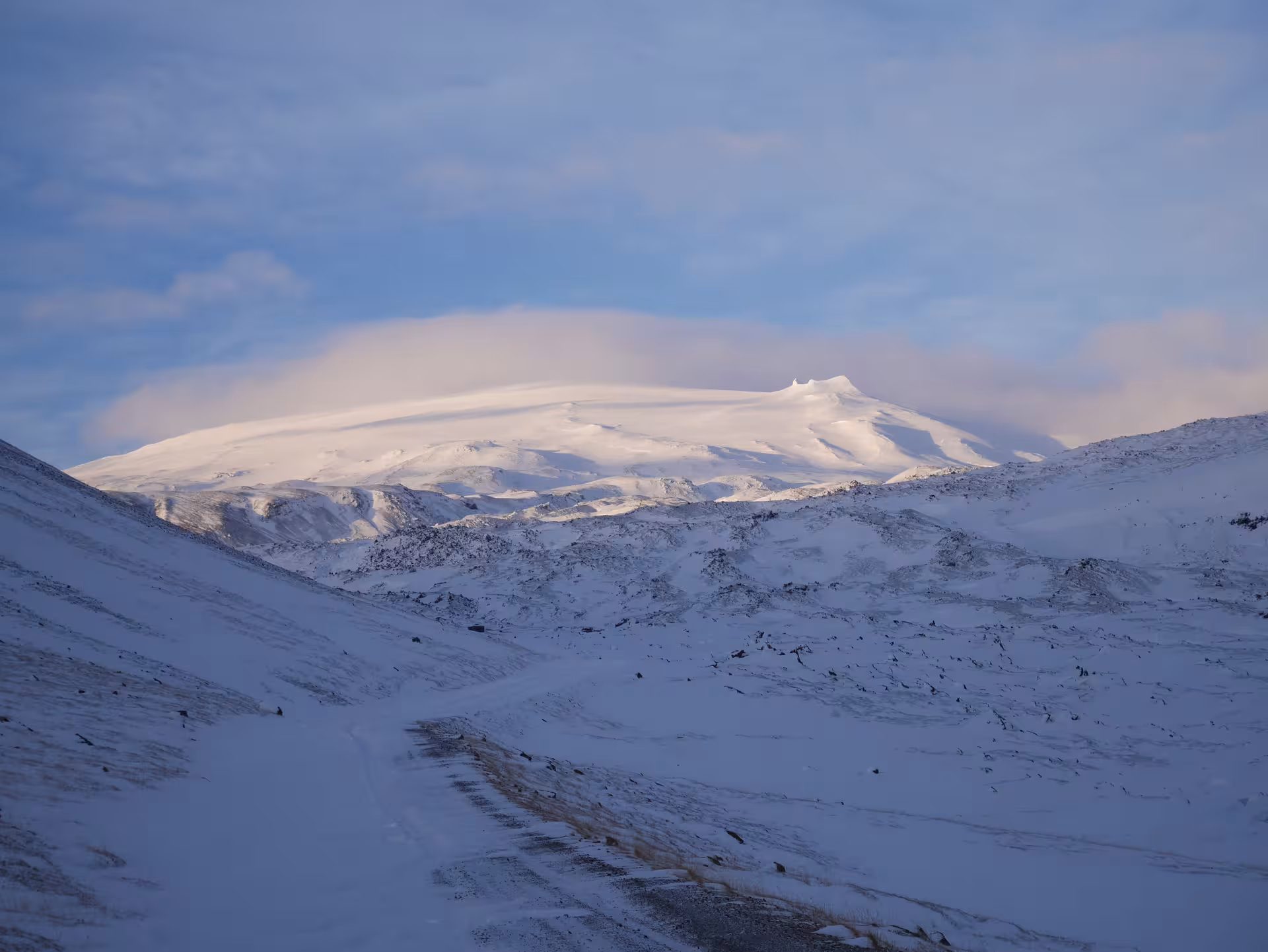 Snow-covered Snaefellsjokull glacier volcano with lenticular cloud cap in winter landscape Iceland