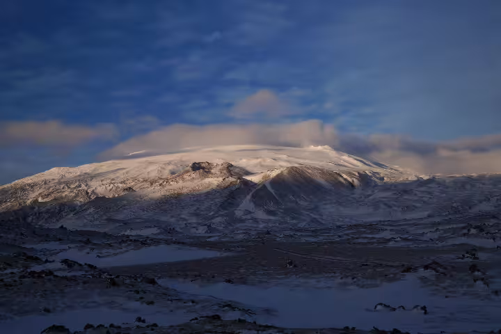 Snow-covered Snaefellsjokull glacier volcano under blue sky with clouds in Iceland