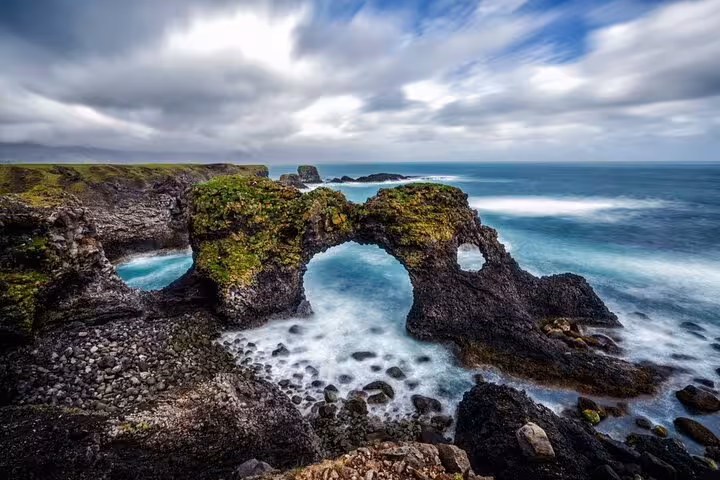 Gatklettur rock arch on Snaefellsnes Peninsula Iceland with turquoise ocean waves