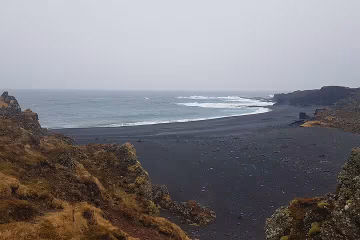 Black sand beach with crashing waves on the Snaefellsnes Peninsula, Iceland, viewed from rocky cliffs