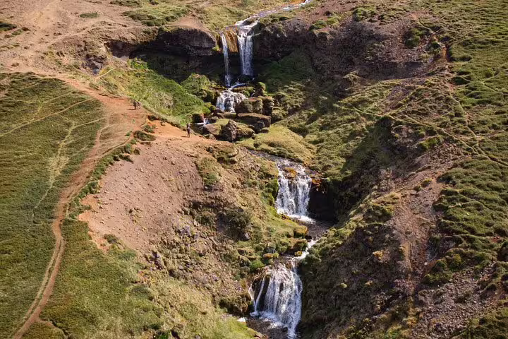 Cascading waterfalls flowing through green mossy canyon on Snaefellsnes Peninsula, Iceland