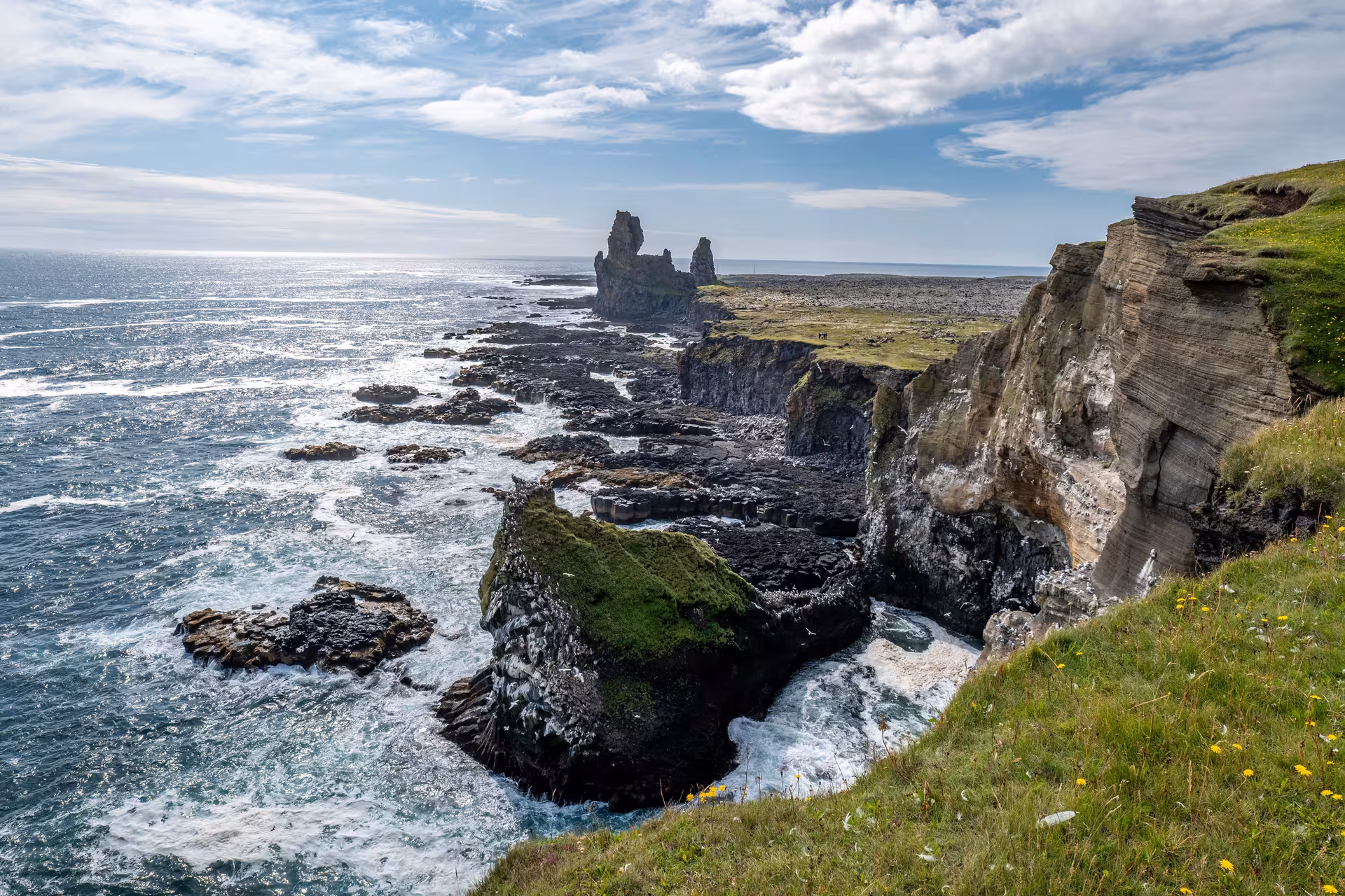 Rocky coastal cliffs and sea stacks along Snaefellsnes Peninsula with crashing Atlantic waves