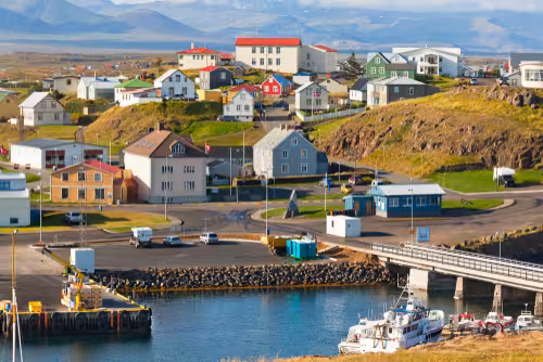 Colorful coastal village with harbor and boats on Snaefellsnes Peninsula, Iceland