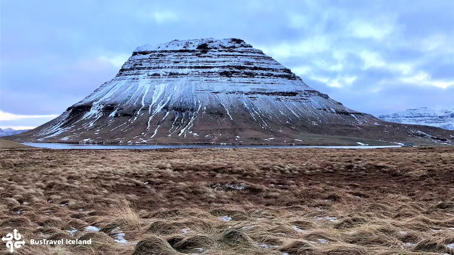 Snow-dusted flat-topped mountain rising above a fjord on the Snaefellsnes Peninsula, Iceland