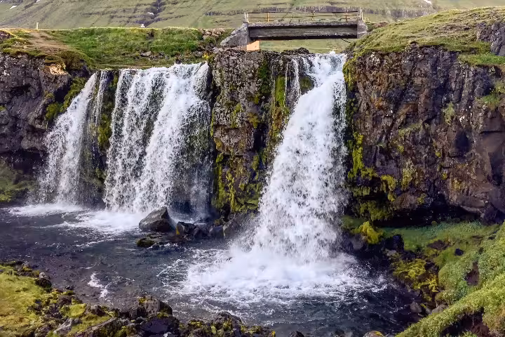 Twin waterfalls cascading down mossy volcanic cliffs on the Snaefellsnes Peninsula, Iceland