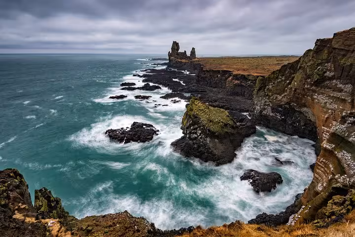 Rocky volcanic coastline with crashing waves and sea stacks at Snaefellsnes Peninsula, West Iceland