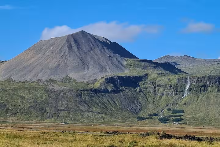 Volcanic cone mountain with waterfall and green cliffs on Snaefellsnes Peninsula, Iceland