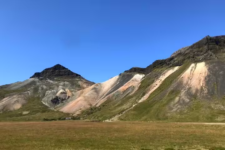 Colorful volcanic mountains with green meadow under clear blue sky on Snaefellsnes Peninsula, Iceland