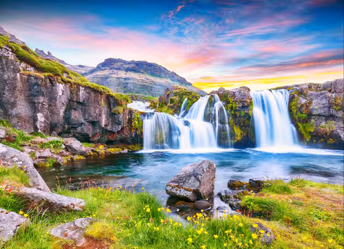 Stunning waterfall cascading into turquoise pool at Snaefellsnes Peninsula Iceland under colorful sunset sky