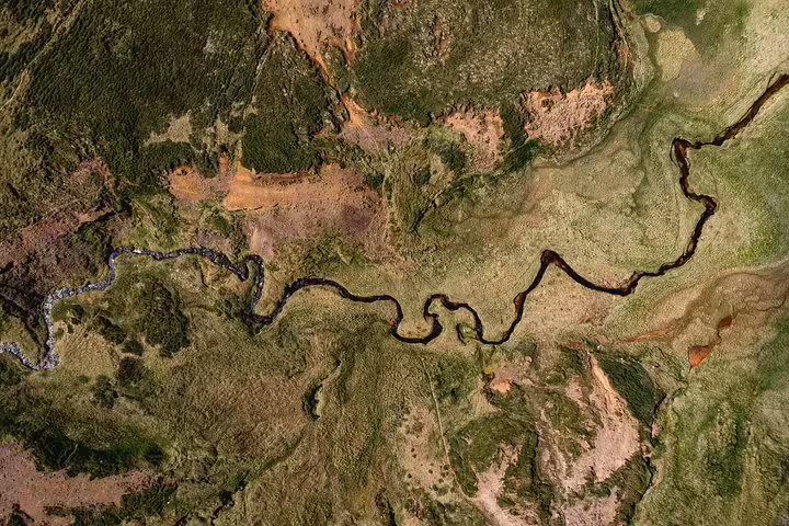 Aerial view of a winding river through the Snaefellsnes Peninsula landscape in Iceland